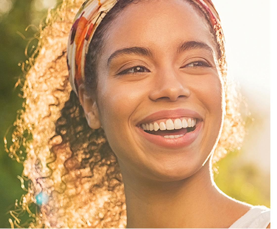 A woman smiling outdoors